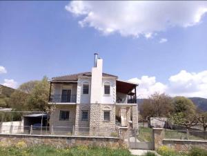a large white house on top of a hill at Traditional Apartment Up to 6 People - ΠΑΡΑΔΟΣΙΑΚΗ ΜΟΝΟΚΑΤΟΙΚΙΑ 6 ΑΤΟΜΩΝ 