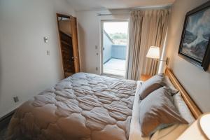 a bedroom with a large bed and a window at Surfcrest Resort in Copalis Beach