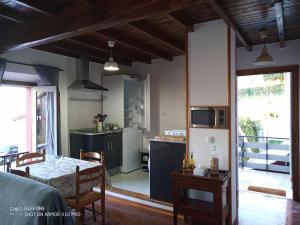 a kitchen and living room with a table and a counter at Casa Chisco in Cudillero