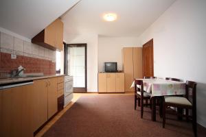 a kitchen with a table and chairs in a room at Vila Vidikovac in Zlatibor