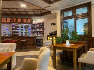a restaurant with tables and chairs and a bar at Motel M Vlasenica in Vlasenica