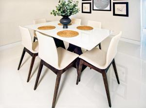 a white dining room table and chairs with a vase on it at Enjoy our Luxurious Penthouse in Condado! in San Juan