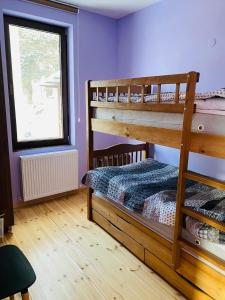a bedroom with two bunk beds and a window at House Near Forest in Bakuriani