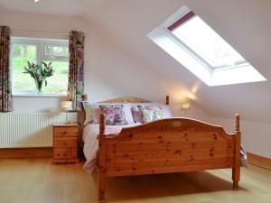 a bedroom with a bed and a skylight at Three Ways in Stroud