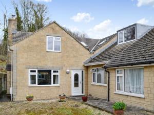 a brick house with a white door and windows at Three Ways in Stroud