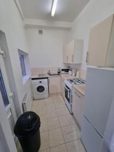 a kitchen with white cabinets and a stove top oven at A home away from home in Birmingham