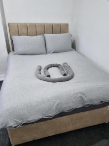 a wooden snake on a bed in a bedroom at A home away from home in Birmingham