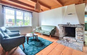 a living room with a couch and a fireplace at Amazing Home In Agunnaryd With Wifi in Agunnaryd