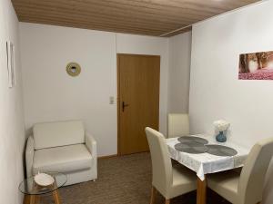 a dining room with a table and a chair at Ferienwohnungen Gmeiner in Bad Endorf