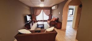 a living room with a couch and a piano at Luxury holiday villas in Bahrain for Families in Bārbār