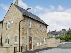 a brick building with a street light on it at Shepley Mews in Glossop