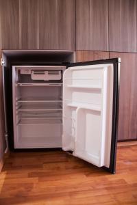 an empty refrigerator with its door open in a kitchen at Star Suites México in Mexico City