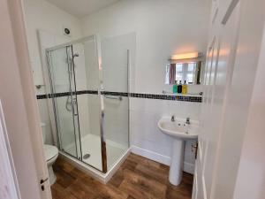 a bathroom with a shower and a sink and a toilet at Georges Place in York