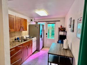 a kitchen with a sink and a refrigerator at Close to beaches with hot tub and large garden in Sarasota
