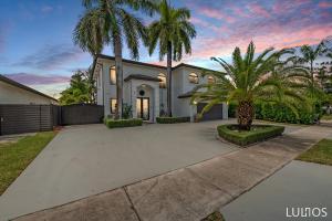 una casa con palmeras frente a una entrada en Luxury Beach Oasis - Heated Pool, Game Extravaganza L44, en Miami