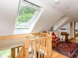 an attic staircase with a large skylight at Riversdale Cottage in Neatishead