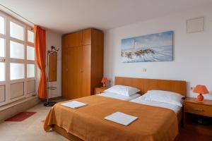 a bedroom with a large bed with two towels on it at Studio and Room Lena in Dubrovnik