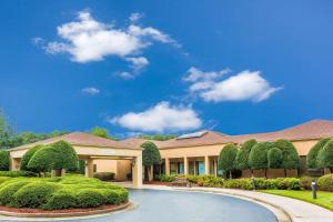 a large house with a driveway in front of it at Comfort Inn Roswell-Dunwoody in Roswell