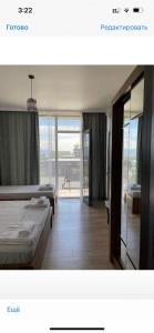 een hotelkamer met 2 bedden en een balkon bij Cozy Rooms in Kobuleti