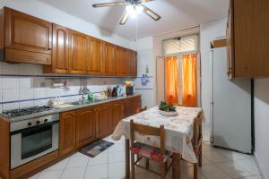 a kitchen with a table and a stove and a refrigerator at Salvanna Centro Storico in Naples