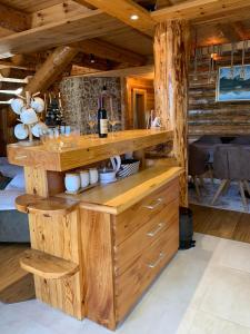 a room with a wooden counter with a bottle of wine at Alpine House in Žabljak