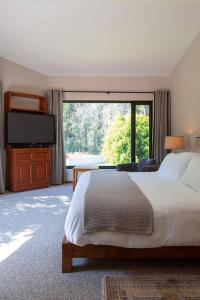 a bedroom with a large bed and a large window at Casa Ficus, serviced Luxury Villa with pool&tennis in Valle de Bravo +61 photos