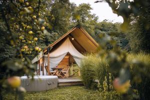 a large tent with a porch in a forest at Luxury vineyard resort Chateau Ramšak in Maribor