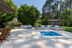 a patio with couches and a swimming pool at Casa Ficus, serviced Luxury Villa with pool&tennis in Valle de Bravo