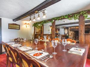 a dining room with a long table with wine glasses at Old Rydon Inn in Kingsteignton