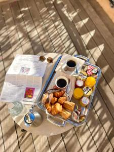 a table with a tray of food and two cups of coffee at Best Western Plus La Corniche in Toulon