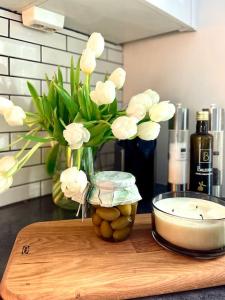 a vase of white flowers on a cutting board at New apartment near the lifts tourist center Trysil in Trysil