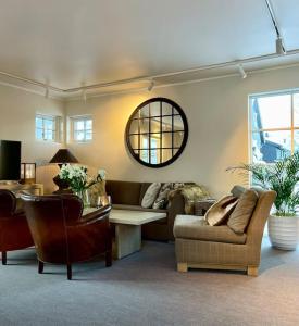 a living room with a couch and a table at New apartment near the lifts tourist center Trysil in Trysil