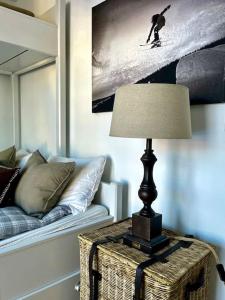 a lamp on a table in a living room with a couch at New apartment near the lifts tourist center Trysil in Trysil