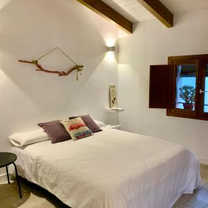 a bedroom with a white bed and a window at LA MOMA Apartments & Room in Xàtiva