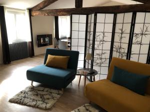 a living room with a couch and a chair at La Pignotte in Avignon
