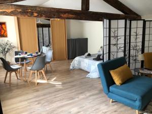 a bedroom with a bed and a table and chairs at La Pignotte in Avignon +19 photos