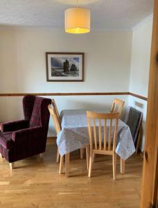 a dining room with a table and a chair at Stornoway Holiday Let in Stornoway