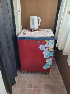a red refrigerator with a white jug on top of it at Mi casa in Salta