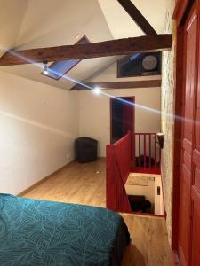 a bedroom with a bed and a staircase in a room at Charmante maison de ville in Bolbec