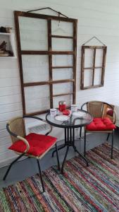 a table with two chairs and a table with at Savikulma B&B in Mynämäki