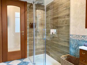 a shower with a glass door in a bathroom at Appartement Auber in Nice