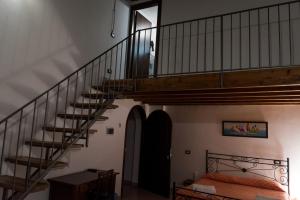 ein Schlafzimmer mit einer Treppe und einem Bett mit einer Tagesdecke in der Unterkunft Alla Loggia Del Gattopardo in Palermo