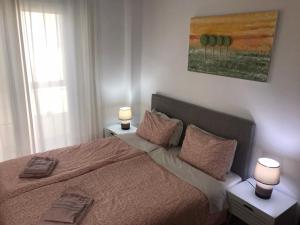 Posteľ alebo postele v izbe v ubytovaní Cosy Seaside Apartment