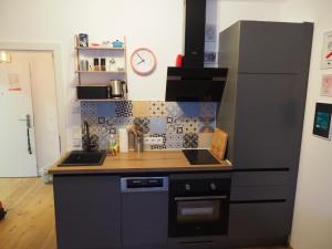 a kitchen with a black refrigerator and a counter at Ahorn 4 in Gröbming