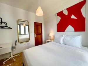a bedroom with a bed and a desk and a mirror at Urbana Hotel in San Juan