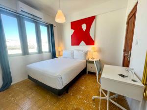 a hotel room with a bed and a desk and a table at Bahia Urbana Hotel in San Juan