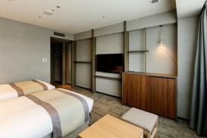 Postel nebo postele na pokoji v ubytování HOTEL VISCHIO TOYAMA