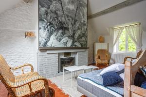 a bedroom with a fireplace and a bed in a room at Le Moulin de Dannemarie in Dannemarie