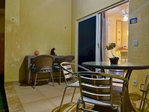 a dining room with a table and chairs in a room at Solar Água Duplex Top in Pipa