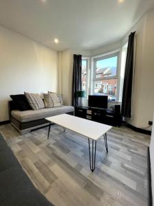 sala de estar con sofá y mesa en Newly refurbished 3 bedroom entire terraced house, en Lincolnshire